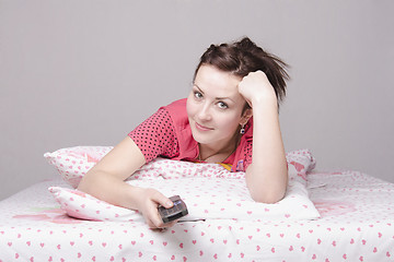 Image showing girl lying in bed and watching TV
