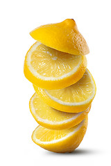 Image showing Falling slices of lemon isolated on white background