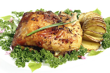 Image showing Fried chicken thighs  with roast potatoes hasselback