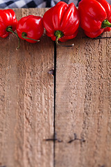 Image showing Red chili peppers on wooden board
