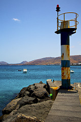 Image showing spain lighthouse and harbor pier boat in the blue sky   