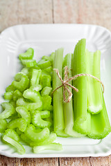 Image showing bundle of fresh green celery stems in plate 