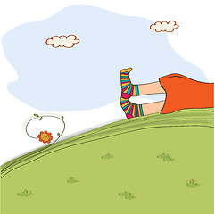 Image showing bored girl legs lying on the grass