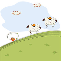 Image showing two cheerful sheep jumping on grass