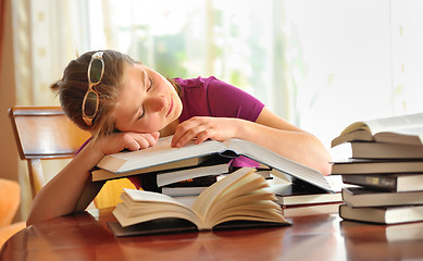 Image showing teenager girl sleeping on books