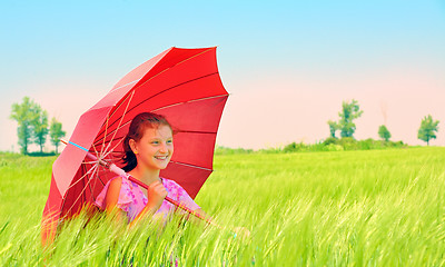 Image showing Girl with umbrella at field