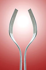 Image showing silver forks forming tall wine glass