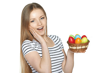 Image showing Surprised female holding basket with Easter eggs