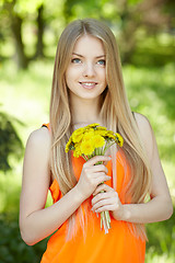 Image showing Spring girl with bunch of dandelions