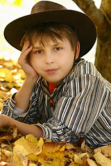 Image showing Child in autumn leaves