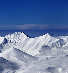 Image showing View on off-piste snowy slope at nice sunny day