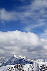 Image showing Winter snowy mountains and sky with clouds at nice day