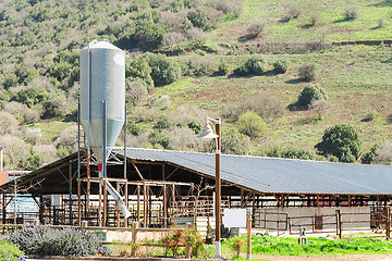 Image showing Rustic cowshed with silo in the countryside