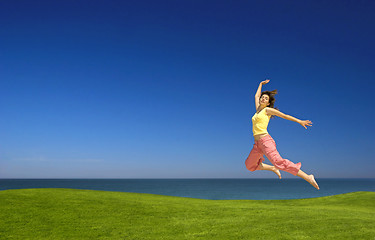 Image showing Young woman jumping