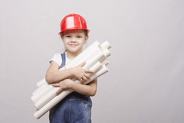 Image showing Girl stands with a bunch of drawings