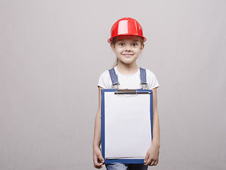 Image showing Child mechanic in helmet and with folder his hands