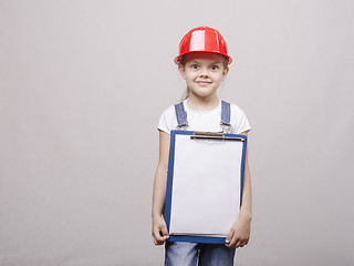 Image showing The child in a helmet and with folder his hands