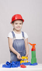 Image showing Girl builds a house from the designer