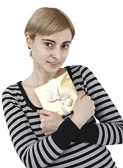 Image showing Young woman holding a present