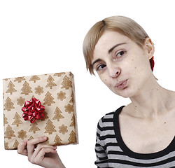 Image showing Young woman holding a present
