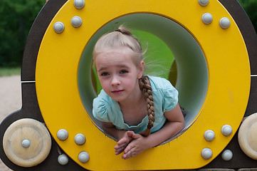 Image showing Young girl sitting in crawl tube