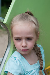 Image showing Serious beautiful girl on the playground