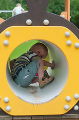 Image showing Young boy sitting in crawl tube