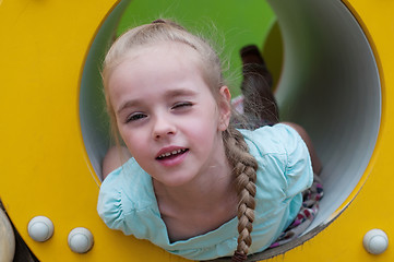 Image showing Young girl lying in crawl tube