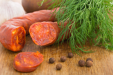 Image showing Chorizo sausage sliced on wood chopping board