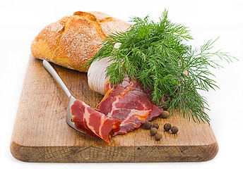 Image showing Rustic still life with bacon, bread, garlic and herbs