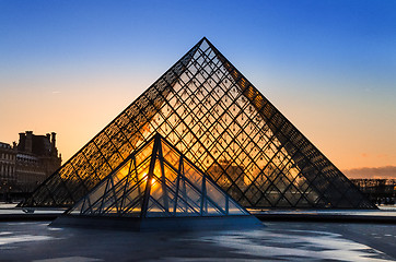 Image showing Sunset shines through the glass pyramid of the Louvre museum