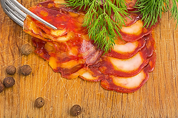 Image showing rustic still life with a slice of sausage