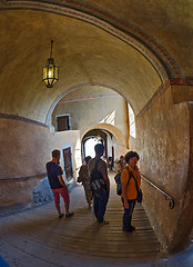 Image showing Tourists walk along the corridors of a medieval castle