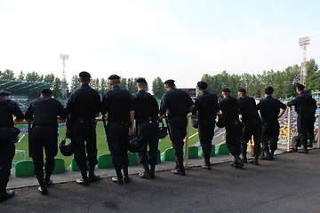 Image showing policemen standing guard over order in the stadium