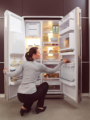 Image showing woman looking for something to eat
