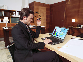 Image showing businessman with laptop in office l