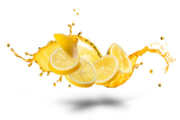 Image showing Falling slices of lemon with juice splash isolated on white