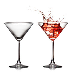 Image showing empty an? full martini glass with red cocktail with splash isol