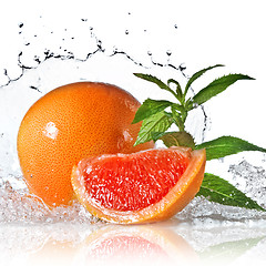 Image showing Water splash on grapefruit with mint isolated on white