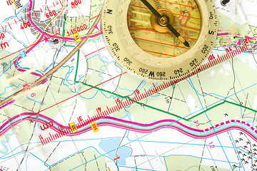Image showing old touristic compass on map 