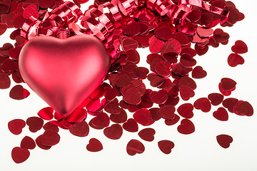 Image showing small red confetti and big hearts on white background