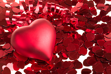 Image showing small red confetti and big hearts on white background