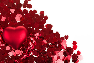 Image showing small red confetti and big hearts on white background