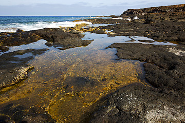 Image showing beach  light  water   lanzarote foam rock spain    stone sky clo