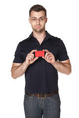 Image showing Cheerful male showing red card in hand