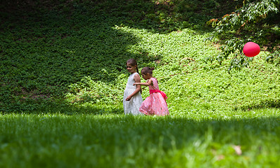 Image showing Two little girls walking in park