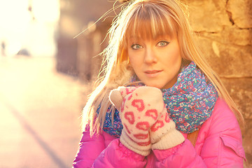 Image showing Woman warming her hands in mittens