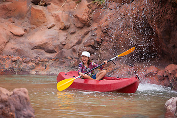 Image showing Happy little girl on a kayak on a river at summer 