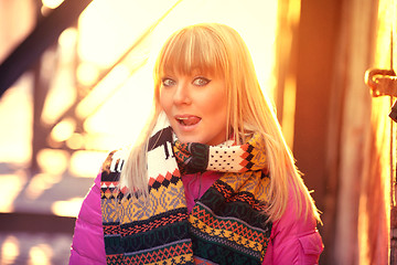 Image showing Happy woman sticking out tongue in the sun