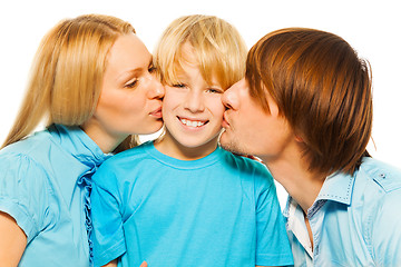 Image showing Mother and father kiss boy